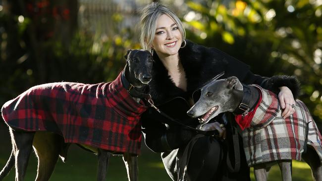 Stylist Erin Paige Stevenson with her retired greyhounds Harry and Pixie Picture: John Appleyard