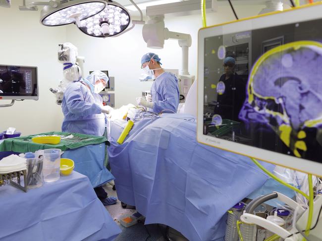 Supplied undated image obtained Wednesday, August 30, 2017 of medical professionals performing neurosurgery at the Ramsay Health Care-operated Greenslopes Private Hospital in Brisbane. Ramsay Health Care has lifted full-year net profit 8.6 per cent to $488.9 million on the back of growth in admissions and procedural volumes across the company's Australian business. The country's largest private hospital operator said revenue from services for the year to June 30 grew marginally, up 0.2 per cent, to $8.7 billion, from $8.68 billion a year ago. (Ramsay Health Care)  EDITORIAL USE ONLY