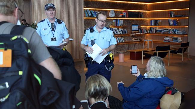 NSW Police officers answer the questions of international travellers taken to Sydney’s Rydges Hotel where they will be quarantined. Picture: Matrix