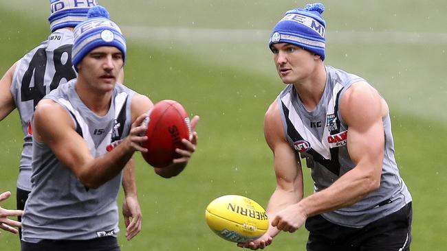 Power midfielder Ollie Wines, right, scored 142 SuperCoach points against the Tigers in Round 12.