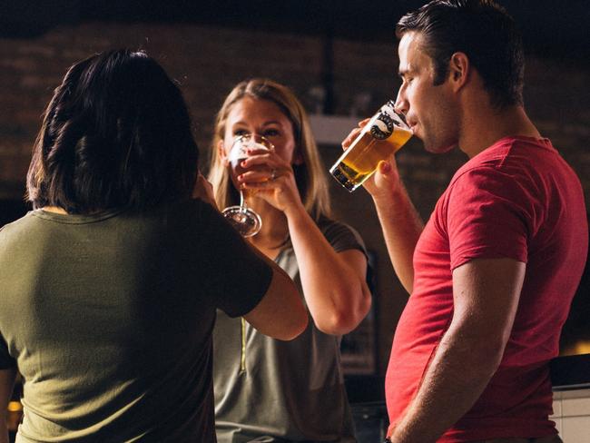 Patrons standing and drinking at a pub, bar, having a beer.  For 'vertical consumption' ban story. Credit, Pexels, Elevate.