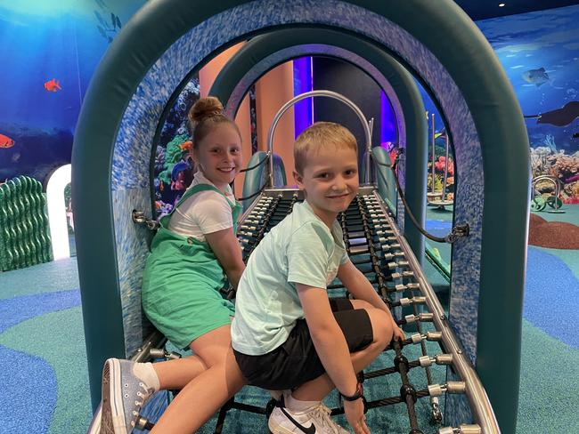 Kayla, 10, and Rory Downes, 6, try out the interactive activity based equipment in Reef Play, the new play space in Willows Shopping Centre. Picture: Leighton Smith.