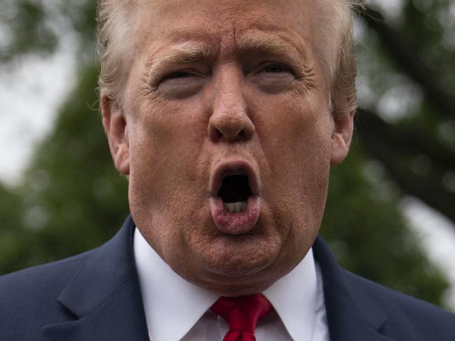 President Donald Trump talks to reporters before departing the White House for a trip to Michigan, Thursday, May 21, 2020, in Washington. (AP Photo/Evan Vucci)