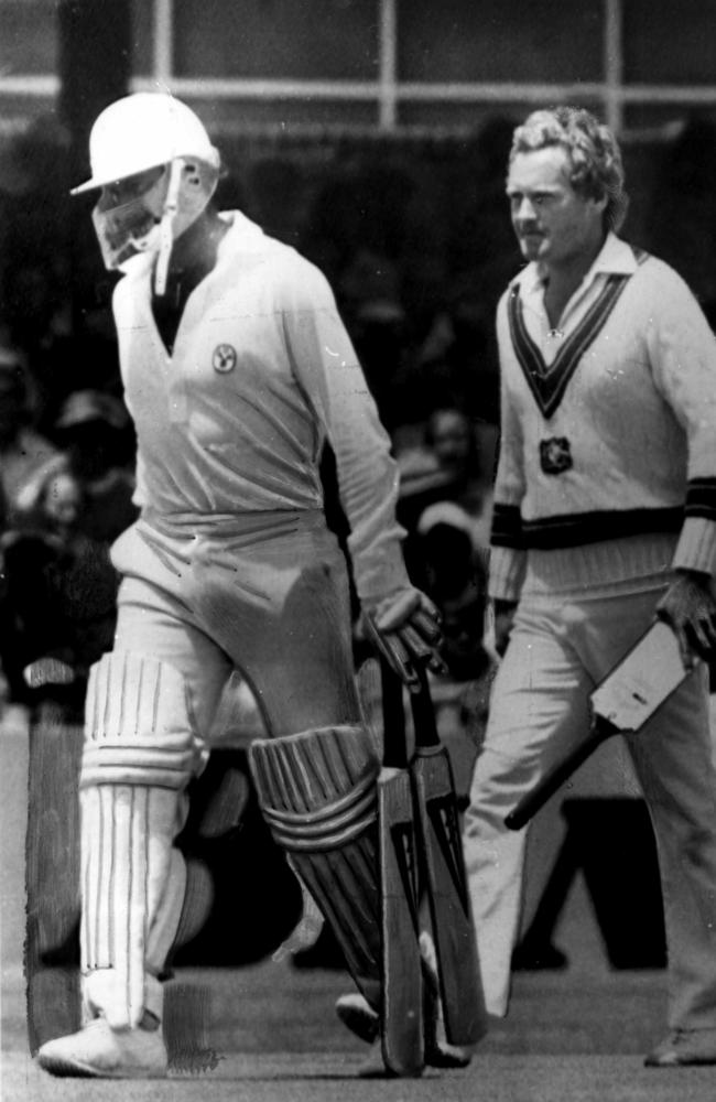 Dennis Lillee walks off the WACA ground carrying two wooden bats followed by teammate Rodney Hogg carrying his new aluminium bat.