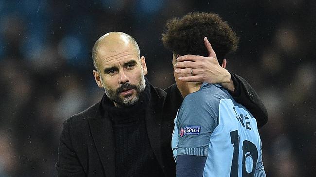 Pep Guardiola (L) consoles Manchester City's German midfielder Leroy Sane.