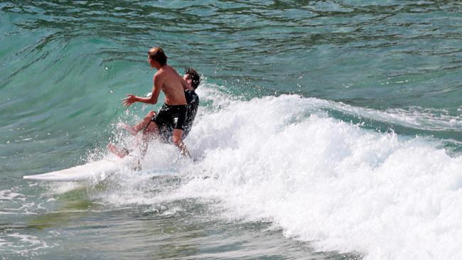 Surfers ignored closure signs and fences at MacKenzies Bay. Picture: Adam Yip