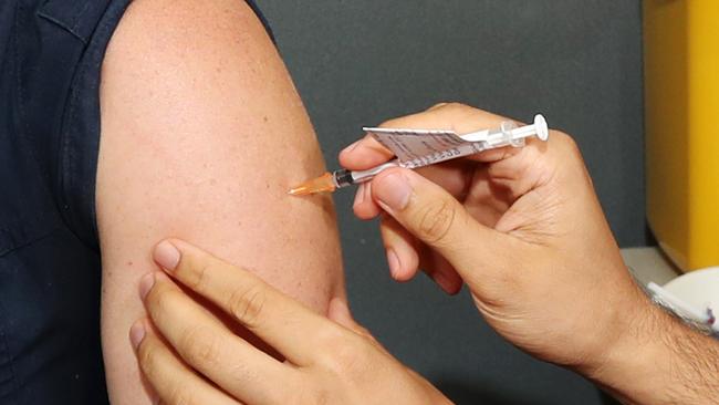 A nurse receives the Pfizer vaccine at Princess Alexandra Hospital in Brisbane. Picture: Tara Croser.