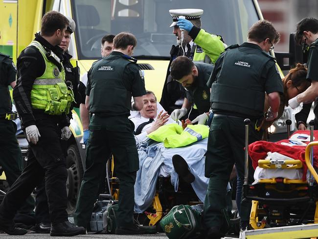 A member of the public is treated by emergency services near Westminster Bridge and the Houses of Parliament in London. The speed and response of emergency services was phenomenal.