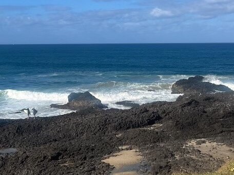 The brothers were brought to the sandy spot in the rocks after they were pulled from the water. Picture: Michael Crisp