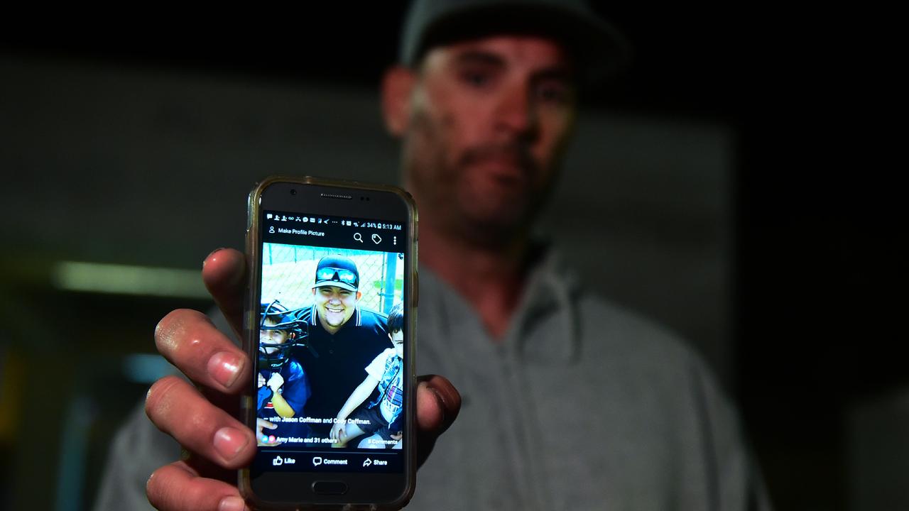 Jason Coffman displays a photo of his son Cody. Picture: AFP