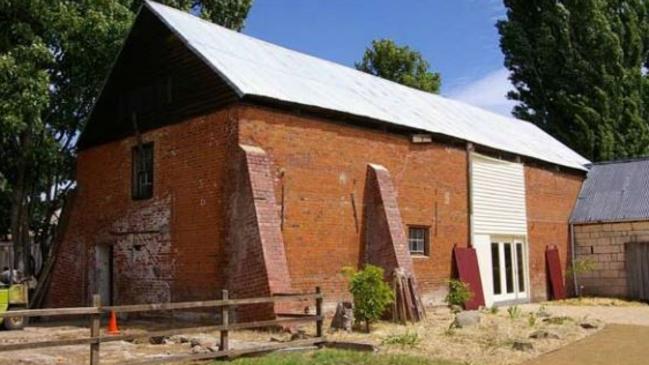 The old granary at Redlands, Tasmania, where hexafoils have been inscribed into the wall to ward off witches.