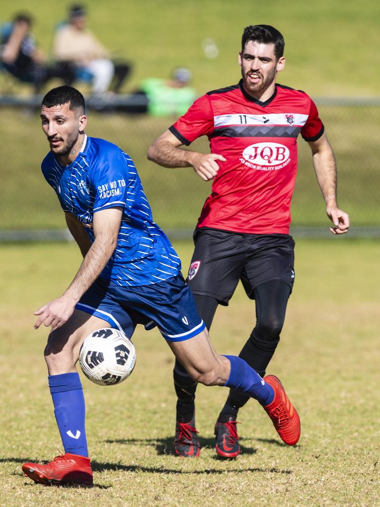 Rockville Rovers player Salih Rasho (left) defends against Nick Guymer of Chinchilla Bears opposition in Div 1 Men FQ Darling Downs Presidents Cup football at West Wanderers, Sunday, July 24, 2022. Picture: Kevin Farmer