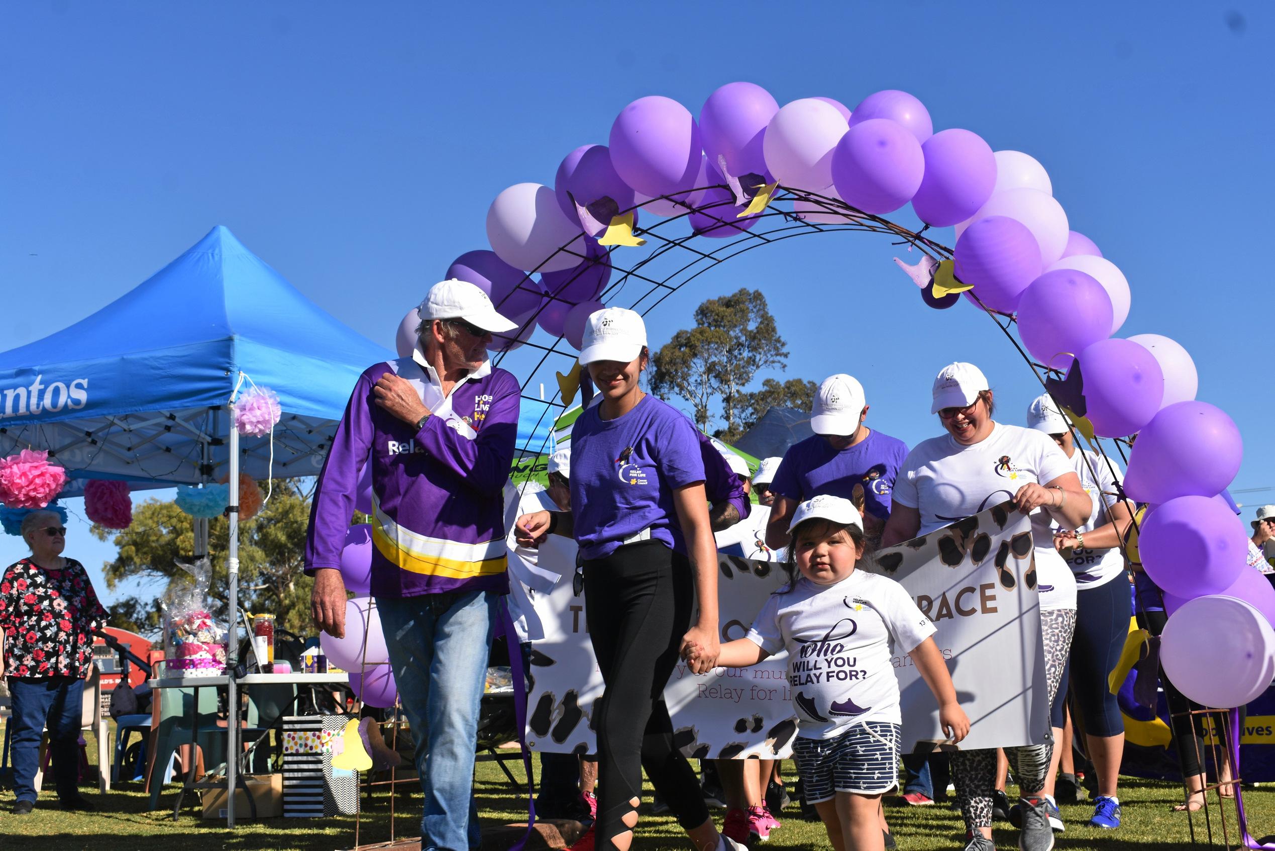 Bryan Vickery and Kaitlyn Landers lead the survivors and carers lap. Picture: Ellen Ransley