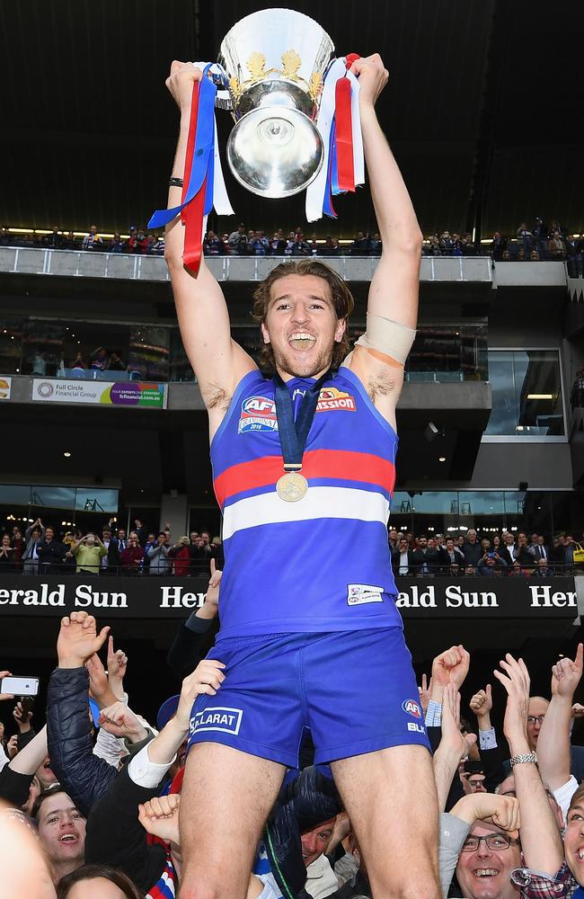 Marcus Bontempelli with the spoils of the Dogs’ premiership win. Picture: Getty Images