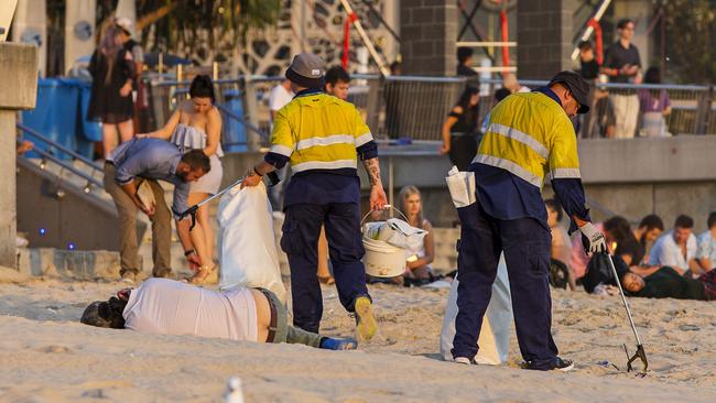 Council workers on the job cleaning up the beach at Surfers Paradise. Picture: Jerad Williams.