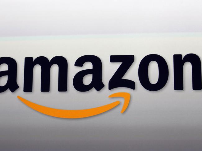 This Sept. 6, 2012 photo shows an Amazon logo at the introduction of the new Amazon Kindle Fire HD and Kindle Paperwhite personal devices, in Santa Monica, Calif. Amazon will report earnings Thursday April 23, 2015. (AP Photo/Reed Saxon)