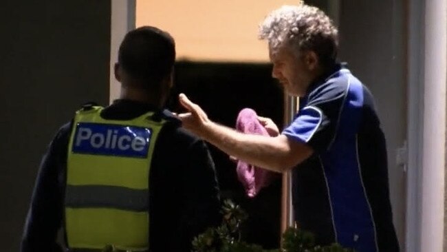 A man, believed to be the alleged victim’s husband, speaks with police outside the home. Picture: Nine News