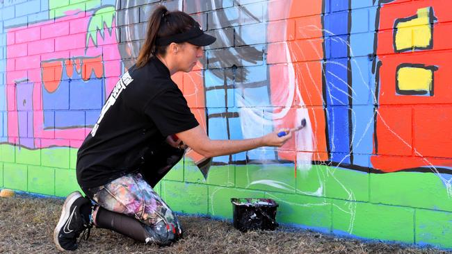 Artist Polly Johnstone – known as Miss Polly – kicks off the first Palmerston Street Art Festival in 2024. Her mural is based on a painting she did as a child, and includes a portrait of her younger self and an amalgamation of her two sons. Picture: Sierra Haigh