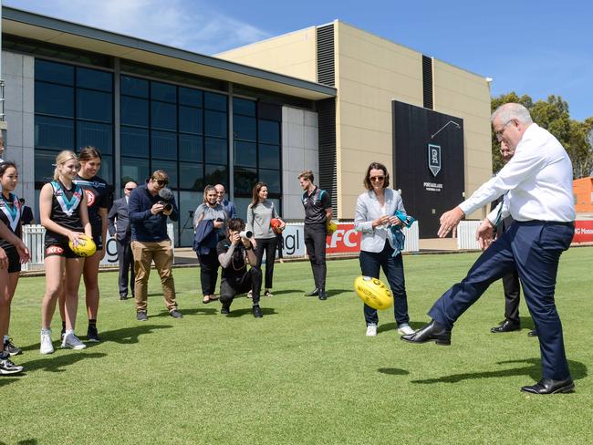 NOVEMBER 26, 2021:  The Prime Minister Scott Morrison has a kick with 16yo Chloe Whitington-Charity, an AFLW hopeful from the Next Generation Academy, at Alberton Oval. Picture: Brenton Edwards