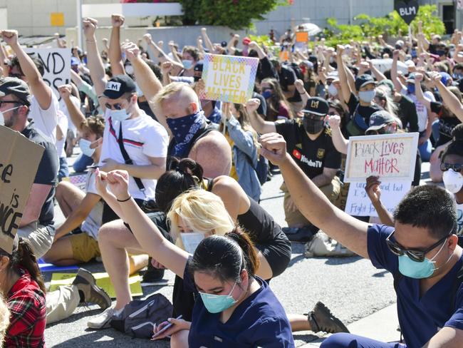 GLENDALE, CALIFORNIA - JUNE 07: Protesters raise fists in solidarity at the Glendale Community March and Vigil for Black Lives Matter on June 07, 2020 in Glendale, California.   Rodin Eckenroth/Getty Images/AFP == FOR NEWSPAPERS, INTERNET, TELCOS & TELEVISION USE ONLY ==