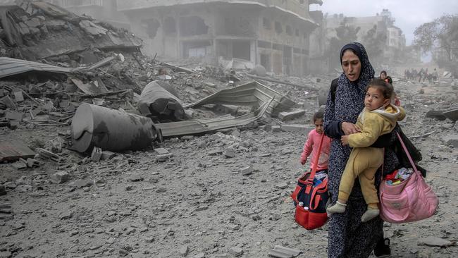 Palestinians flee the area after Israeli bombardment in central Gaza City as Israel continues to bombard Gaza. Picture: AFP