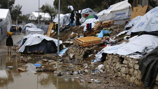 A refugee stands next to a pool of mud at Moria refugee camp on the eastern Greek island of Lesbos in January, 2017. (Pic: Petros Tsakmakis/InTime News via AP)