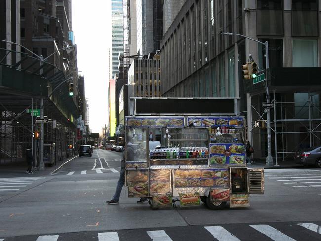 A food truck vendor pushes his cart down an empty street near Times Square in New York. Picture: AP