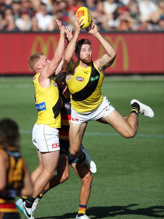 Noah Balta launches for another intercept. Picture: Sarah Reed/AFL Photos via Getty Images