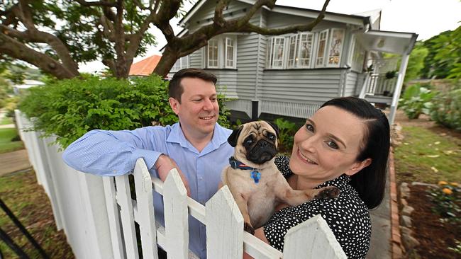 Chris and Melissa Ogden, with their pet listed their Queenslander in Camp Hill for sale this year. Picture: Lyndon Mechielsen