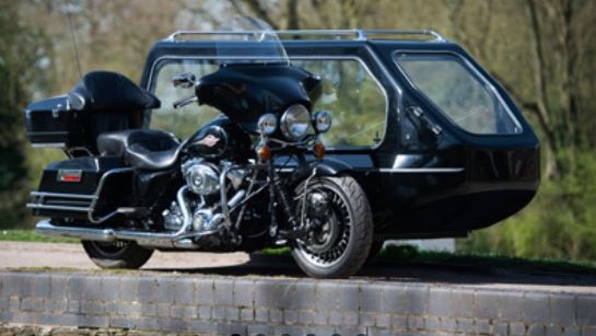 The Harley Davidson Electra Glide motorcyle hearse might be more your style.