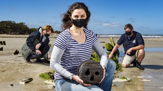 A group of volunteers from Amazon 1863 project Inc need funds to dig up and preserve the Amazon shipwreck on the Inverloch surf beach. Volunteer Trilby Parise at the shipwreck holding a ‘dead eye’ – part of the ships rigging system. Fellow volunteers (left), Karyn Bugeja and Adrian Brewer inspect the wreck. Picture: Sarah Matray