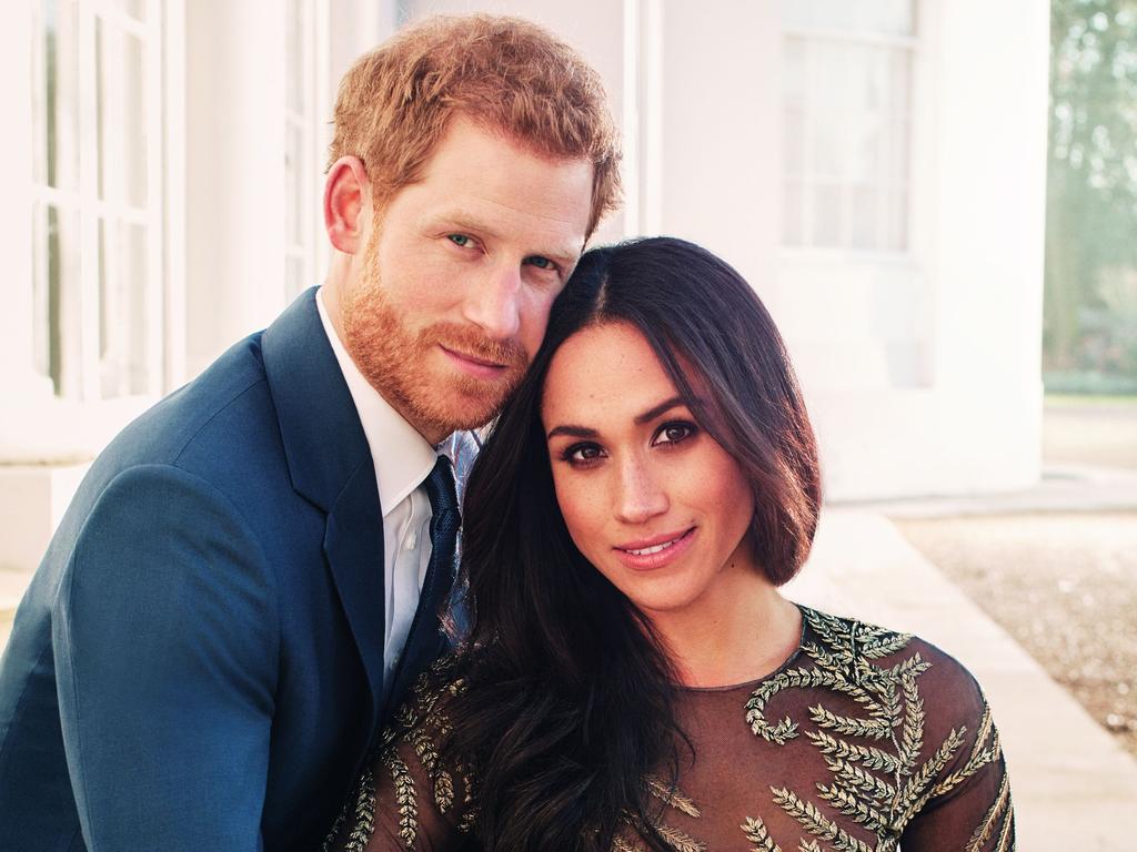 Prince Harry posing with his fiance Meghan Markle where she wore a Ralph and Russo dress at Frogmore House in Windsor. Picture: AFP