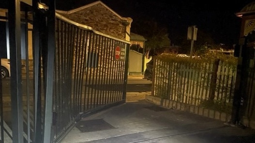 The busted-open gates at the rear of the Lexus dealership on West Terrace. Picture: SAPOL