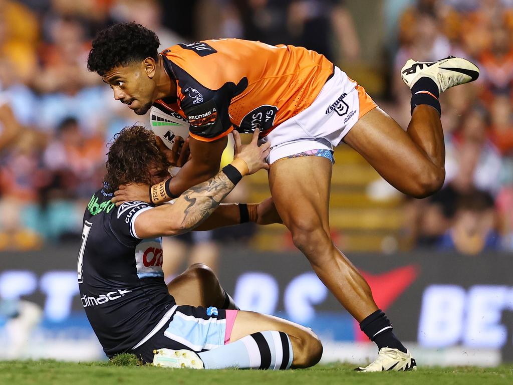 SYDNEY, AUSTRALIA - MARCH 23: Jahream Bula of the Tigers is tackled by Nicholas Hynes of the Sharks during the round three NRL match between Wests Tigers and Cronulla Sharks at Leichhardt Oval, on March 23, 2024, in Sydney, Australia. (Photo by Jeremy Ng/Getty Images)