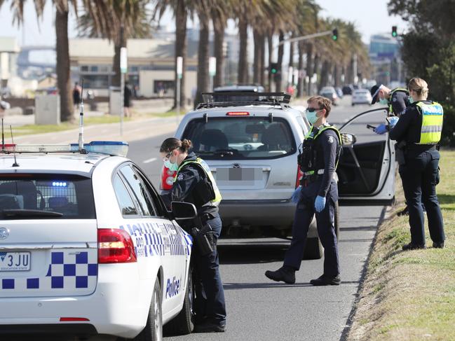 MELBOURNE, AUSTRALIA- NewsWire Photos SEPTEMBER 1, 2020: Police conduct roadside checks in Middle Park on he first day of spring as people are seen exercising along the foreshore during a stage four COVID-19 lockdown in Melbourne. Picture: NCA NewsWire/ David Crosling