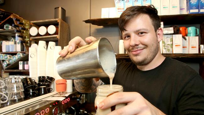 Cafes and restaurants will be able to reopen after no new cases for two complete incubation cycles. Izak Fogarty at Alcove Cafe and Deli, Wilston. Picture: AAP/Steve Pohlner