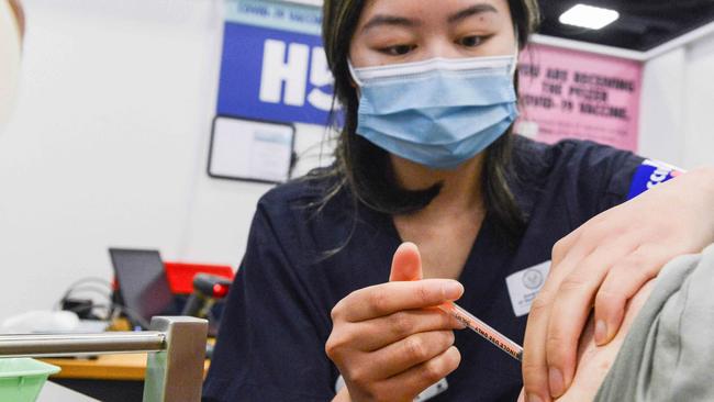 ADELAIDE, AUSTRALIA - NewsWire Photos NOVEMBER 4, 2021: SA Health vaccinator Xuan gives paramedic Sharon Hennessy a Covid booster vaccine at Wayville Vaccination Clinic. Picture: NCA NewsWire/Brenton Edwards