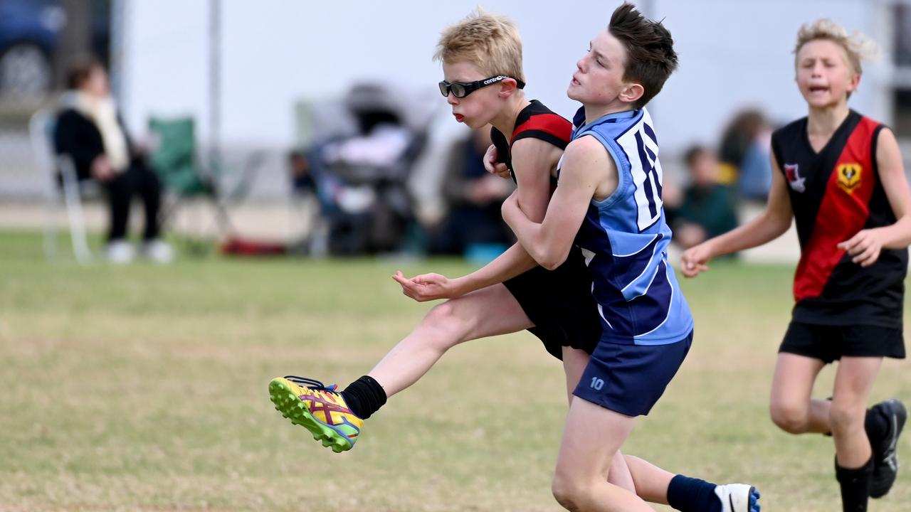 SA Little Legends – celebrating school sport: Here, freelance news photographer Naomi Jellicoe captures some on field action between the Riverland and Mid North, from School Sport SA Sapsasa State Country Football Carnival at West Beach.