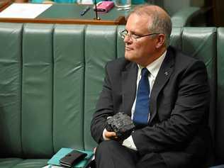 Australia's Treasurer Scott Morrison pictured holding a piece of coal during House of Representatives Question Time at Parliament House in Canberra, in February. Picture: LUKAS COCH