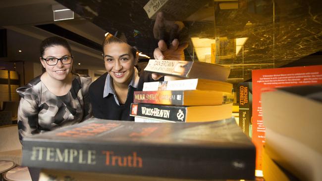 Revesby Workers Club has come up with a novel idea to get the elderly and young people with special needs reading. Pictured is Michelle Sammut from Revesby Workers Club and Kirsten Saisanas from Bankstown City Aged Care. Photo: Melvyn Knipe