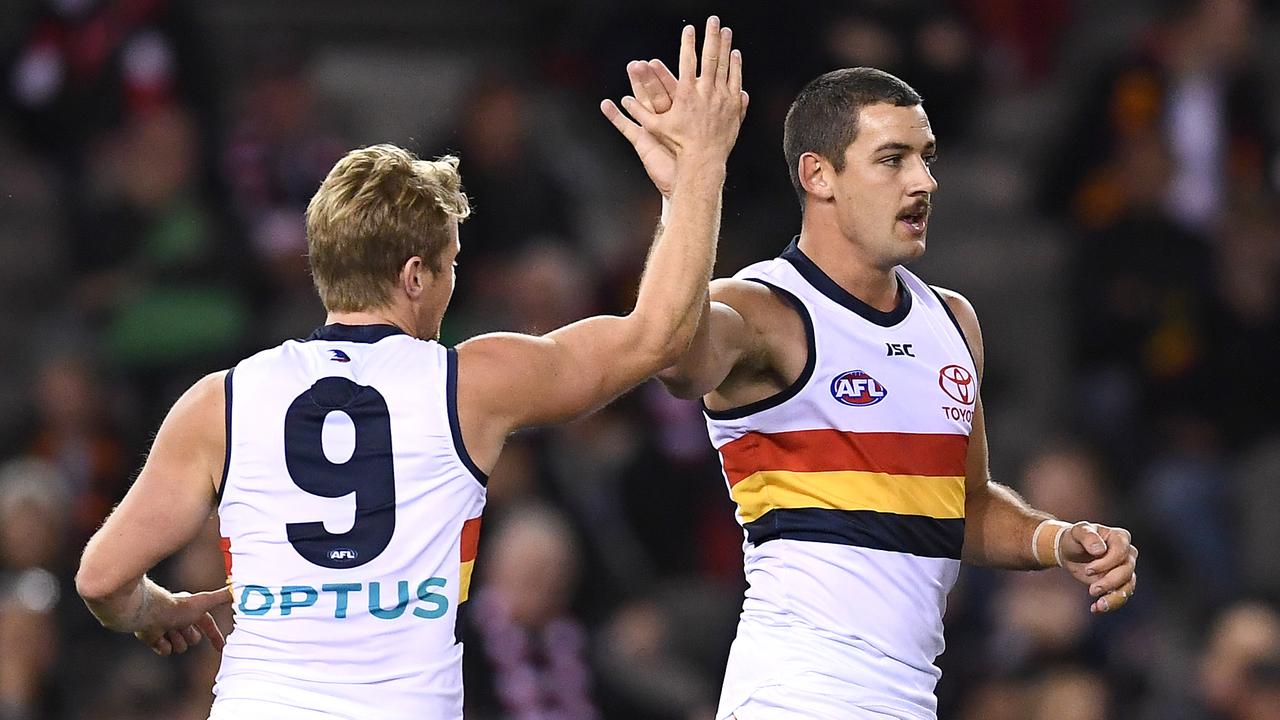 Taylor Walker of the Crows is congratulated by Rory Sloane after kicking a goal during the round 6 match against St Kilda. Picture: Quinn Rooney/Getty Images