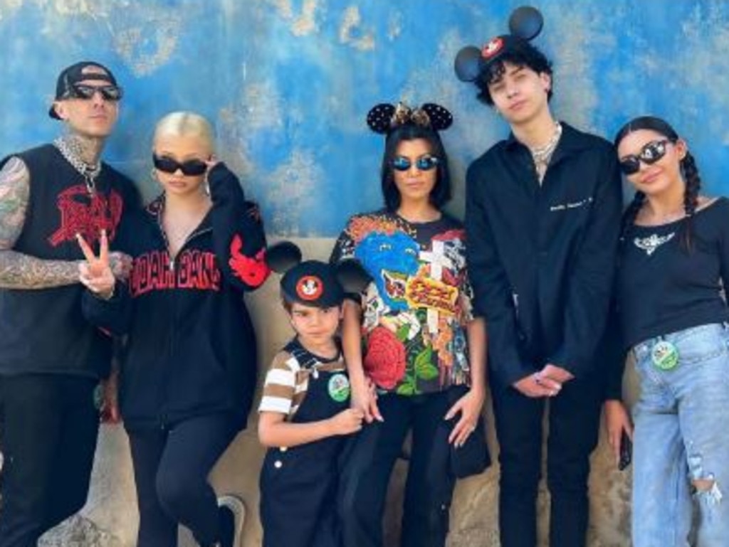 Barker and Kourtney at Disneyland with four of their six kids in 2022.