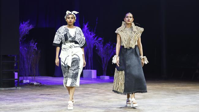 Amariah Savage and Sarah Eggmolesse wear Delvene Cockatoo-Collins designs at the Cairns Indigenous Art Fair fashion performance, Woven, held at the Tanks Arts Centre, Edge Hill. Picture: Brendan Radke