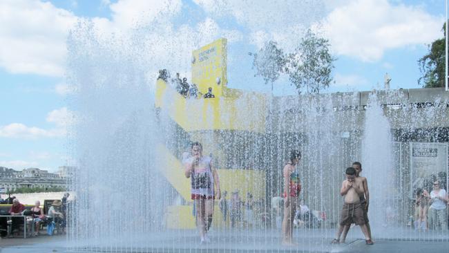 ESCAPE: London Southbank, Kerry Parnell -  London, UK - 21st June 2014: Unidentified children enjoying summer play fountains in London Southbank center. Unidentified adults sitting at nearby cafe and walking around are also visible in the photo . Picture: iStock