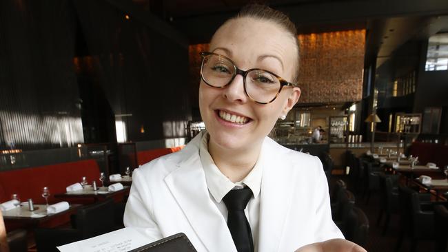 Rockpool Bar and Grill waiter Megane Ducret, hands over the bill with a big smile hoping for a big tip. Picture: David Caird