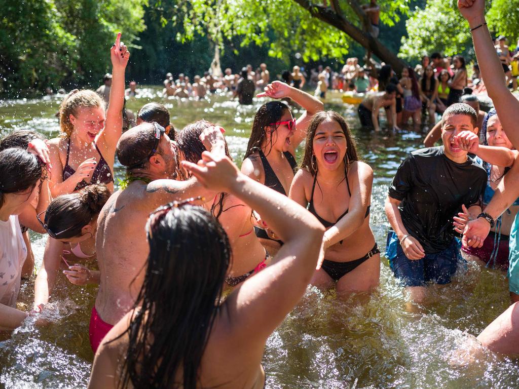 Young people cool off in East London in June. Picture: Tolga AKMEN / various sources / AFP