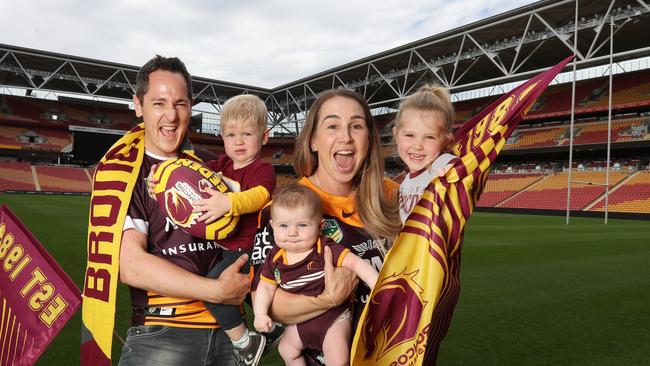 Broncos fans Grant and Charlotte Thomas with their children Noah, 1, Arabella, 4, and Georgia, four months, cheering until the end at Suncorp Stadium. Picture: Annette Dew