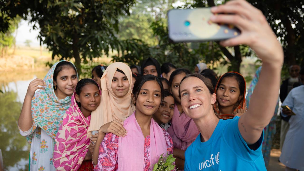 Emma McKeon takes a selfie with locals while inspecting the sanitation facilities and water facilities in Hasanpur village in Feni. Picture: Jason Edwards