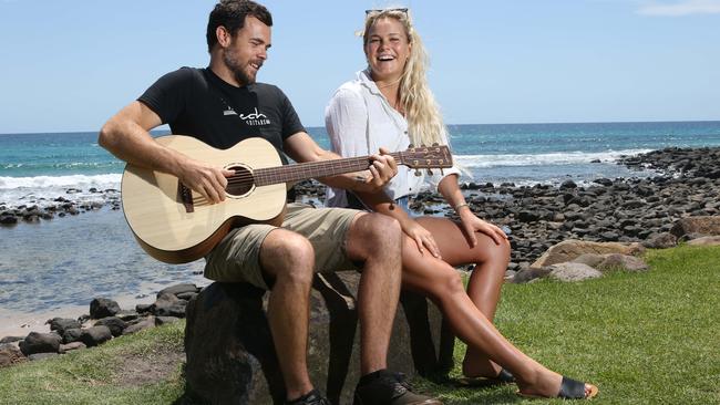 Musician and guitar-maker Aaron Fenech with Felicity Palmateer, who won the women’s single-fin classic last year, at Burleigh point. Picture: Glenn Hampson