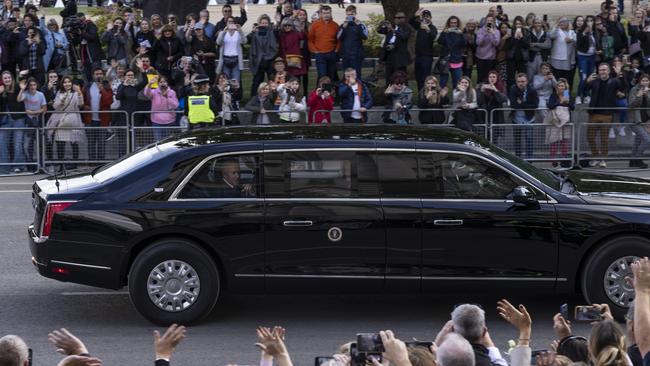 US President Joe Biden and First Lady Jill Biden wave to the crowd from 'The Beast' as they leave Westminster Hall after paying their respects to Queen Elizabeth II.